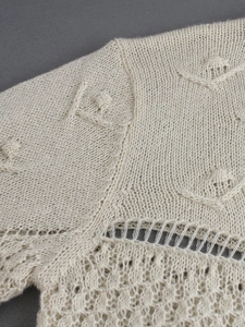 Chic cream knit long sleeve sweater featuring intricate hollow out and bobble stitch patterns