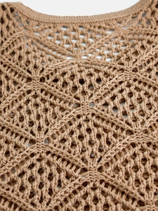 Macro view of geometric crochet knit hollow pattern on the camel-colored vest