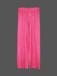 Close-up of rose pink crochet knit texture with hollow out details for beach trousers