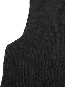 Detail shot of black knitted vest showing high-quality plain stitch fabric texture