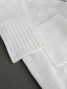White knitted long cardigan with ribbed cuffs and functional patch pocket detail