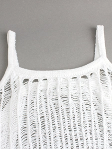 Detail of white knitted strap dress showing distressed laddered textures and fine mesh