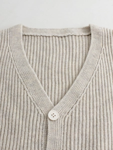 Beige V-neck sleeveless ribbed knit cardigan vest with a single button closure