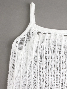 Detail of white crochet knit top with hollow out laddered texture and thin strap