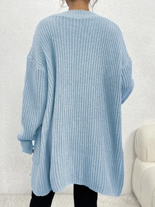 Back view of a light blue oversized chunky knit cardigan showing thick texture and loose fit