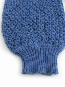 Macro shot of honeycomb knit texture and ribbed cuffs on a navy blue slim sweater