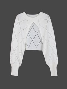 Detail of white knit sweater set with delicate diamond hollow-out pattern and ribbed cuffs