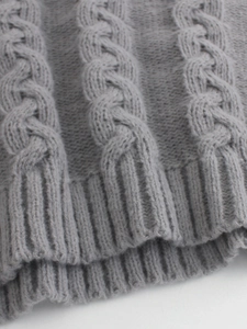 Classic grey cable-knit turtleneck sweater with detailed ribbed cuffs and soft texture