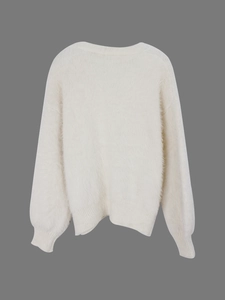 Back view of a white knit cardigan with soft fuzzy texture and ribbed cuffs