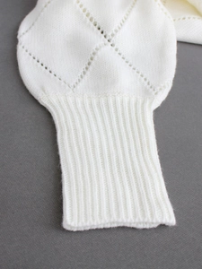 Cream knit sweater featuring diamond hollow crochet pattern and ribbed cuffs details