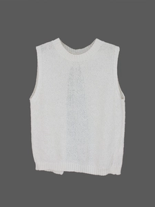 Detail of white knit vest featuring a classic round neck and ribbed hem texture