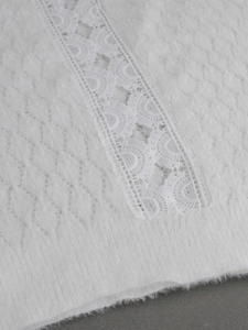 White knit sweater featuring plush faux mink texture and elegant vertical crochet lace detail