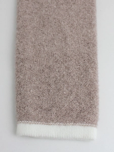 Pink knitted crewneck cardigan sweater featuring white ribbed cuffs and textured wool fabric