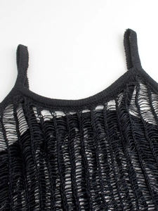 Macro view of black knit halter dress neckline with distressed texture and crochet detail