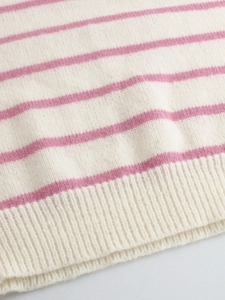 Close-up of pink and white striped knit sweater showing ribbed hem and soft texture