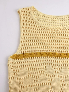 Close-up of hollow knit dress featuring yellow geometric patterns and crochet texture