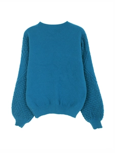 Detailed back view of a blue knitted sweater featuring hollow-out textured sleeves and ribbed cuffs