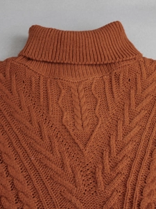 Women's turtleneck knit sweater in caramel orange with cable knit and leaf patterns