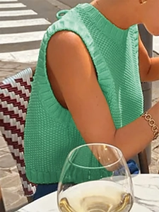 Detailed view of bright green knit tank top showing thick ribbed texture and crew neck