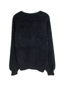 Close-up of black long-sleeve knit cardigan with soft fuzzy faux fur texture details