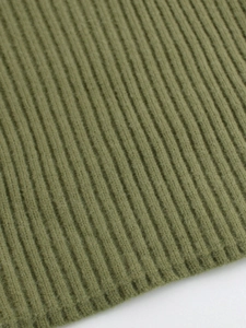 Macro shot of olive green ribbed knit fabric texture for women's sweaters
