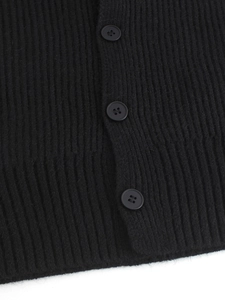 Close-up of black ribbed knit vest showing texture detail and three round buttons