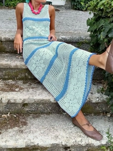 Detail of bohemian hollow knit dress showing contrast stripes and floral crochet texture