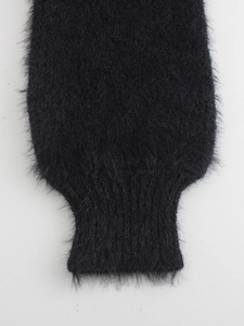 Close-up of black mohair knit sweater showing soft plush texture and ribbed cuff detail