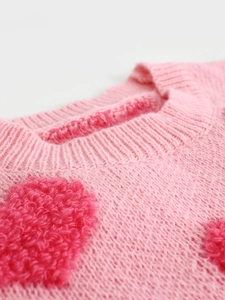 Pink crewneck knit sweater for women featuring a textured 3D bouclé heart pattern