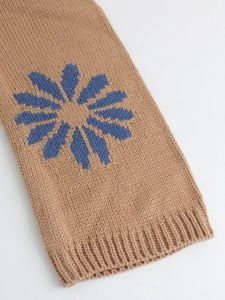 Women's knit pullover sweater in camel featuring blue floral pattern and ribbed cuffs