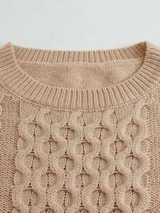 Beige knit sweater vest with round neckline and textured geometric hollow pattern