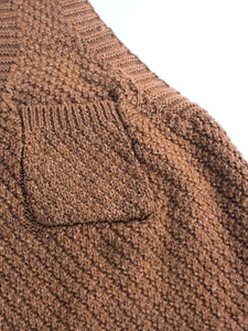 Women's V-neck knit vest in tan brown featuring a textured patch pocket with ribbed trim