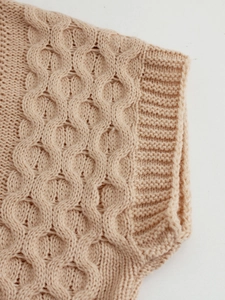 Sleeveless apricot cable knit vest for women featuring intricate hollow patterns