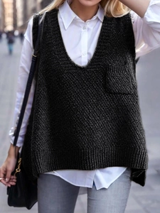 Detail of black V-neck knit vest featuring a single chest pocket and ribbed texture finish