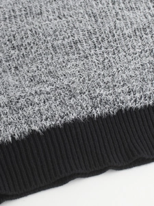 Knitted crewneck sweater featuring grey fuzzy mohair texture and black ribbed cuffs