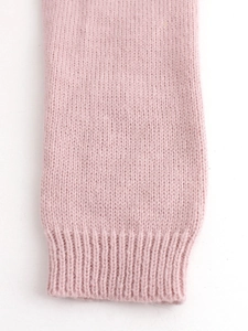 Women's pink knit cardigan featuring long ribbed sleeves and a soft solid texture