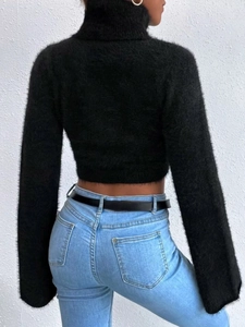 Close-up of black turtleneck knit sweater with fuzzy faux mink texture and cropped fit