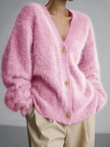 Detail of pink long-sleeve knit cardigan with V-neckline and fuzzy mohair texture