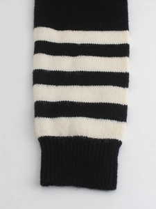 Close-up of black and white striped knit cuff with soft texture and ribbed edge
