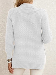 Detailed back view of cream knit sweater showing herringbone texture and side split hem