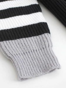 Gros plan du cardigan en tricot rayé noir et blanc avec poignets côtelés gris texturés