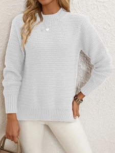 Detail showing the herringbone knit texture and ribbed cuffs of the white crewneck sweater