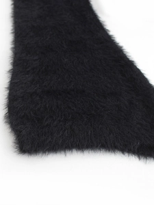 Detail shot of fluffy black mohair knit fabric showing soft texture and high-quality fibers