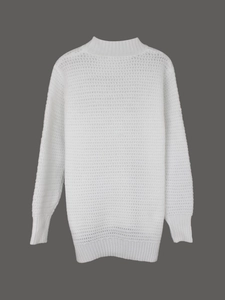 Close-up of white chunky knit sweater texture with ribbed cuffs and neckline details