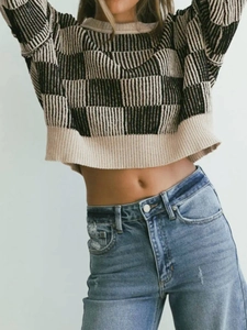 Women's crewneck knit sweater with black and cream checkerboard pattern and ribbed trim
