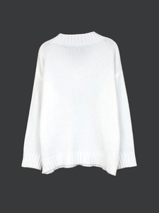 Close-up of ribbed cuffs and hem on a white long-sleeved knit sweater for women