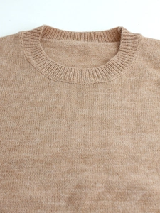 Detail of camel crew neck knit sweater showing high-quality ribbed collar and wool texture