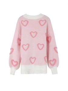 Close-up of pink knit sweater with heart jacquard pattern and white ribbed collar detail