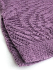 Women's long sleeve dark purple knit sweater with ribbed cuffs on white background