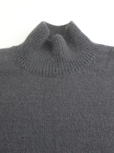 Dark grey knitted mock neck sweater with ribbed collar and soft wool texture detail
